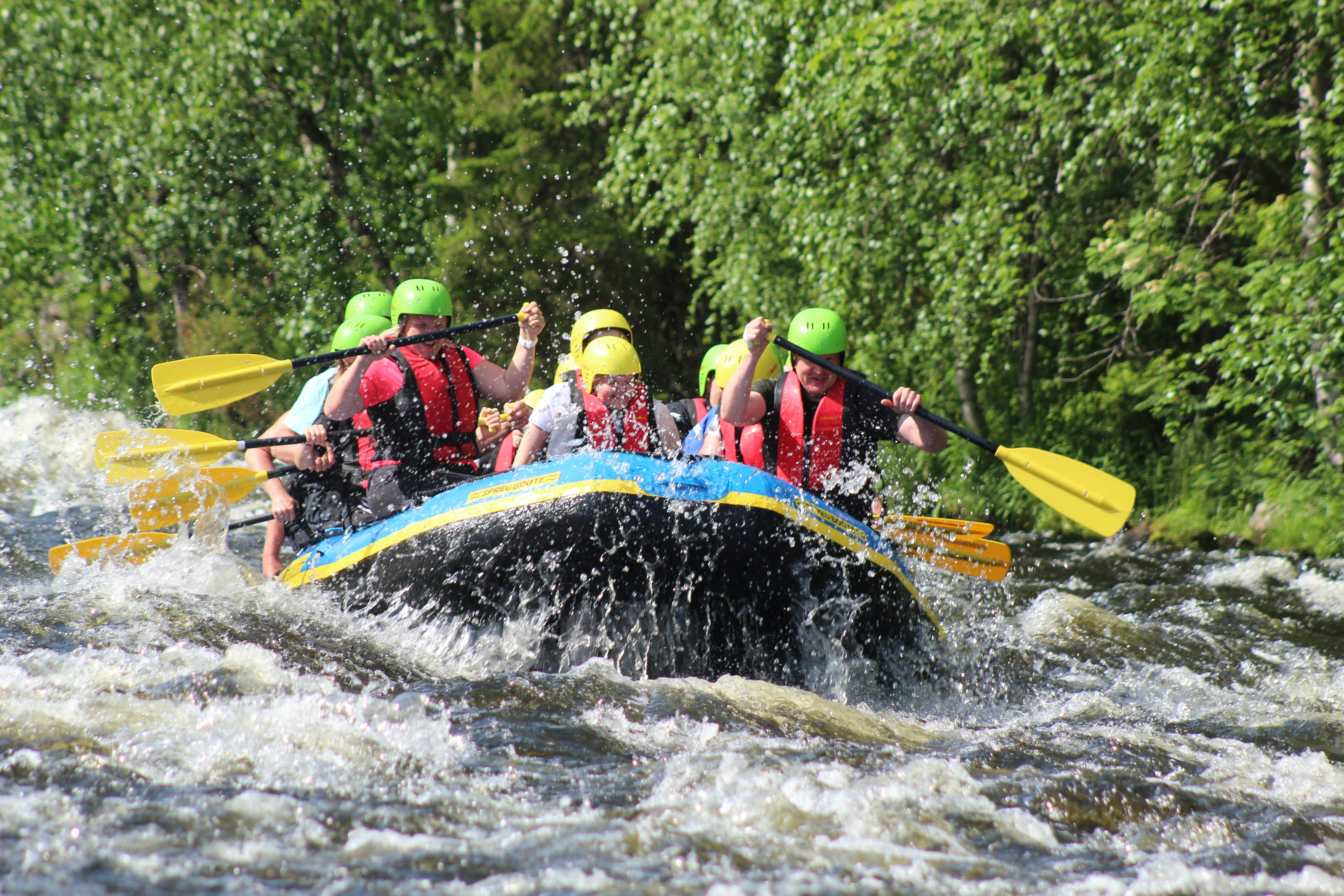 people riding on red kayak on river during daytime